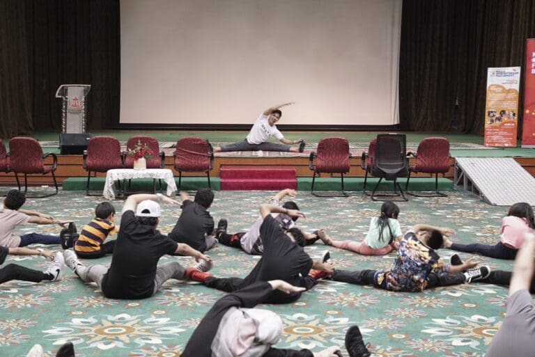 Studio Eleve facilitating the Movements workshop and engaging all the participants to stretch together